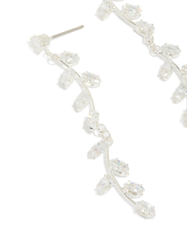 Highlighting dainty long swirling cubic zirconia vine drop earrings featuring leaf accents in silver plated finish close up view