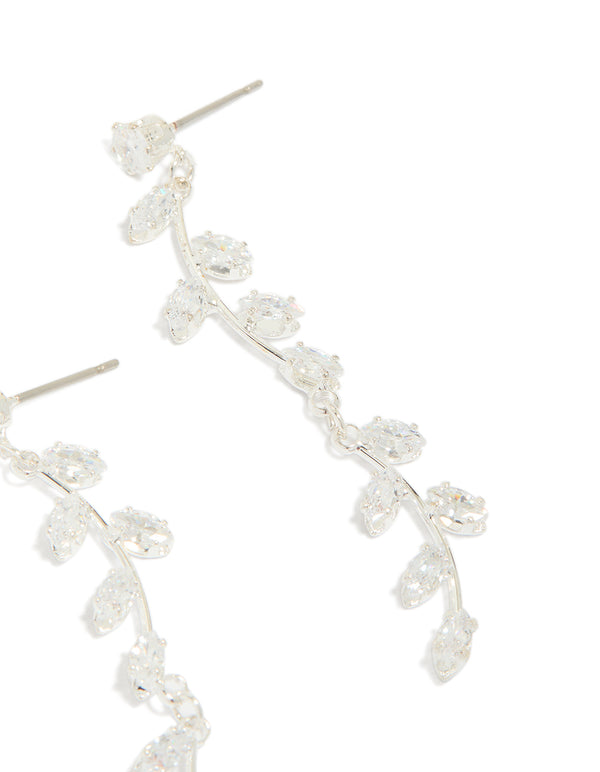 Displaying dainty long swirling cubic zirconia vine drop earrings with leaf embellishments and silver plated construction post detail view