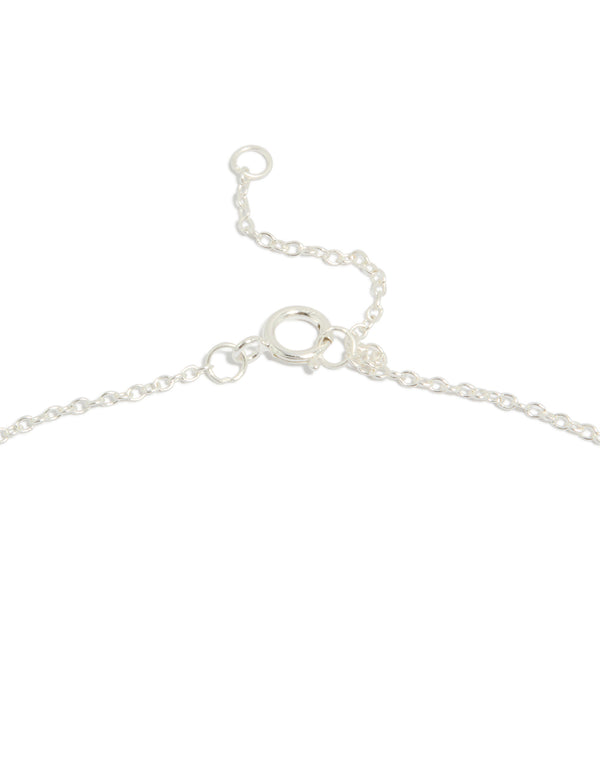 Highlighting a sterling silver cubic zirconia bow pendant necklace with dainty clasp detail view