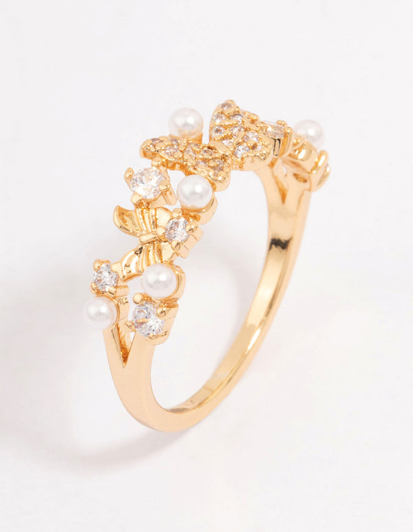 Showcasing a butterfly pearl band ring featuring gold plated metal with cubic zirconia and dainty design side detail view