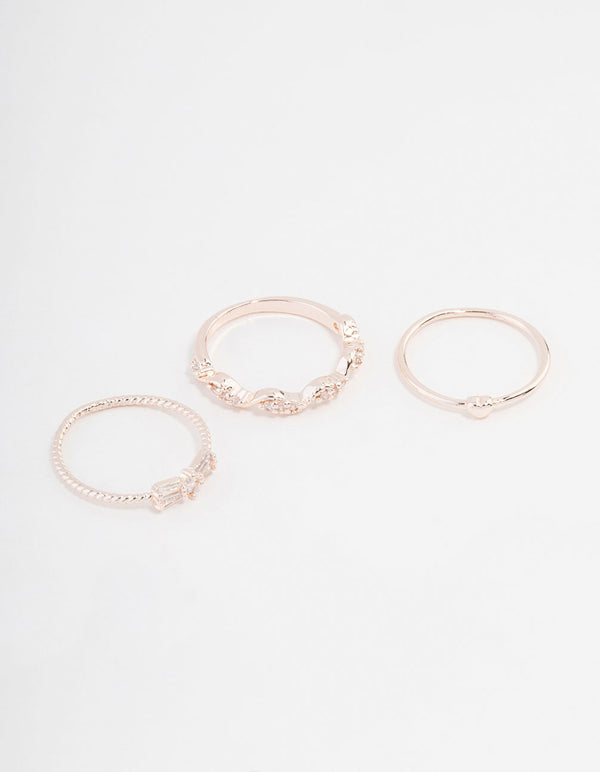 Showcasing rose gold plated rings with mini bow and heart details featuring cubic zirconia in a 3-pack front view