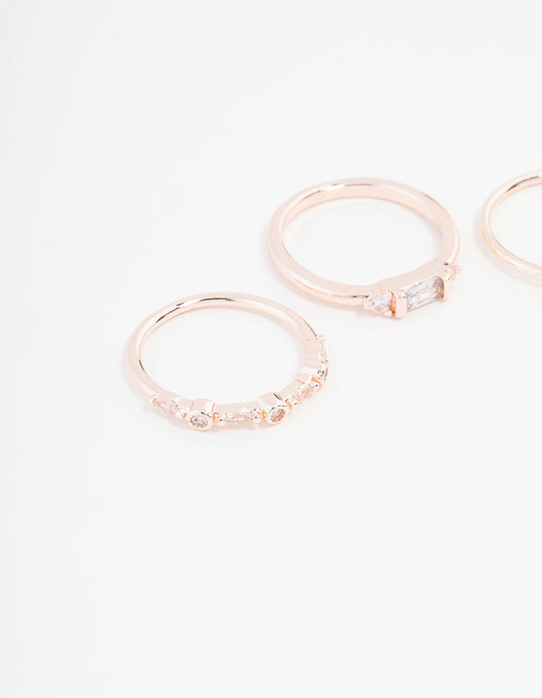 Featuring baguette and round cuts, this rose gold plated cubic zirconia ring 3-pack is shown from a side detail view
