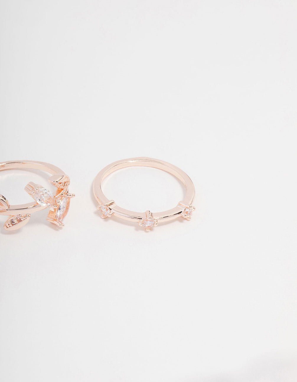 Showcasing rose gold plated cubic zirconia leafy station rings close up view