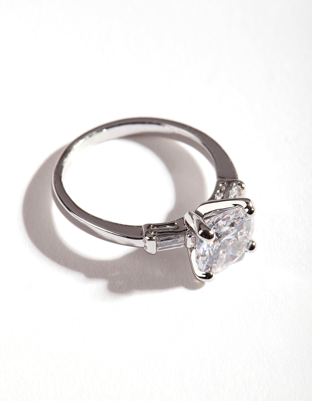 Elegant silver cubic zirconia round stone band ring highlighting prong setting and metal band close up view