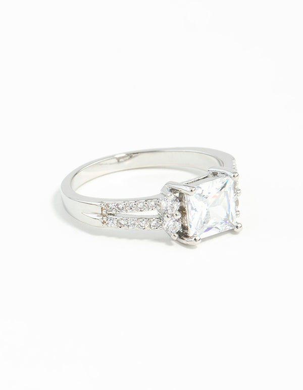Showcasing a silver cubic zirconia square stone ring featuring prong setting and split band front view