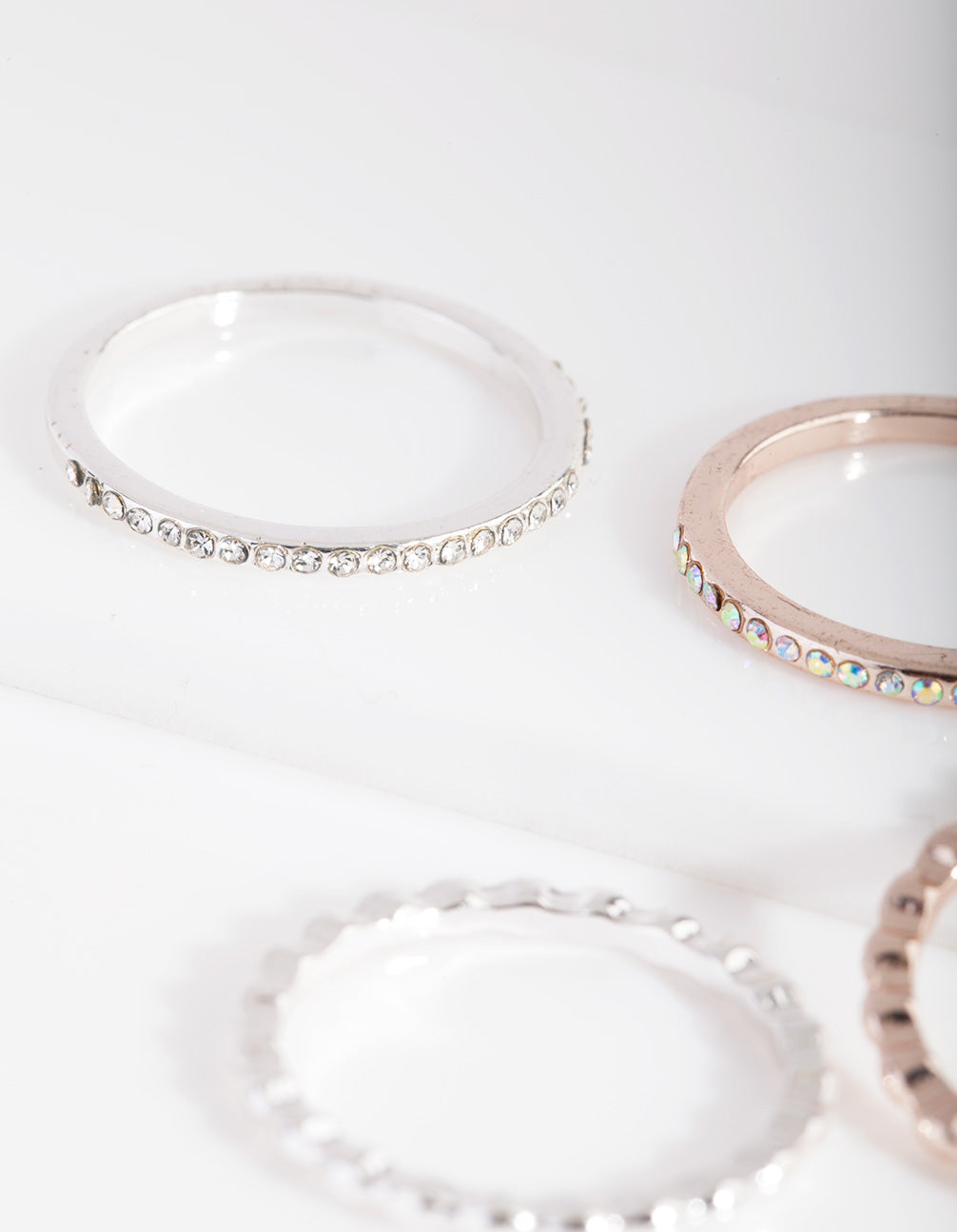 Highlighting mixed metal fine diamante ring 5-pack with iridescent and clear stone settings close up view