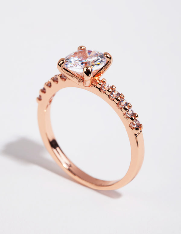 Showcasing a rose gold plated cubic zirconia round band ring with prong setting and pavé accents side detail view