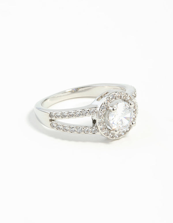 Crafted from silver plated material, this cubic zirconia halo ring features a clear stone in an elegant setting front view