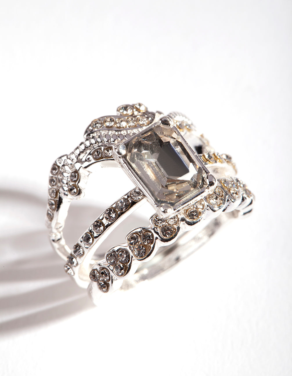 Showcasing a silver baguette multi stack ring with statement design close up view