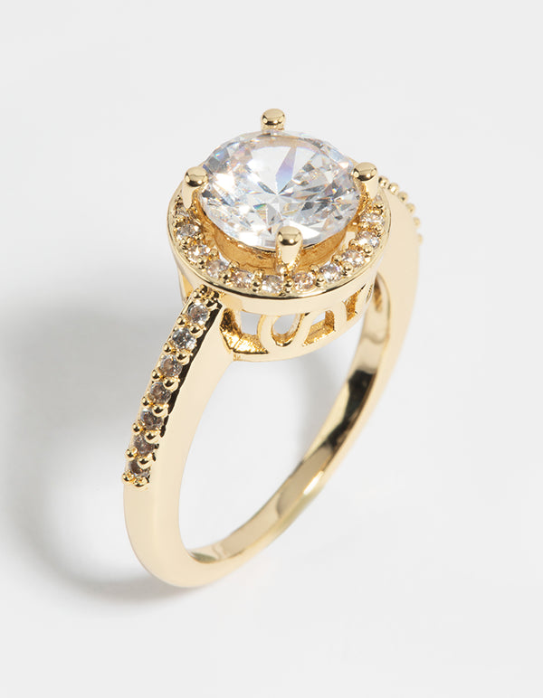 Featuring a gold cubic zirconia solitaire ring with plated metal and statement design side detail view