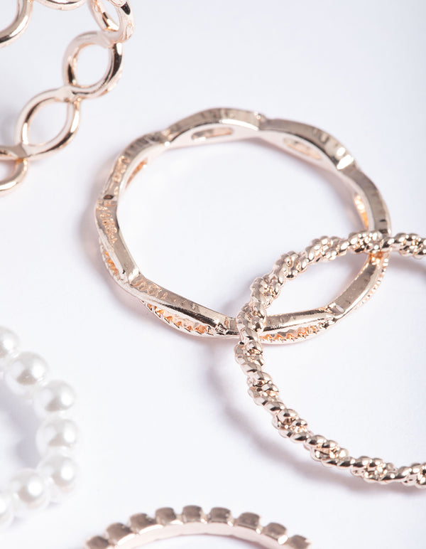 Crafted with pearl and twist design, these dainty rose gold rings are shown in close up view