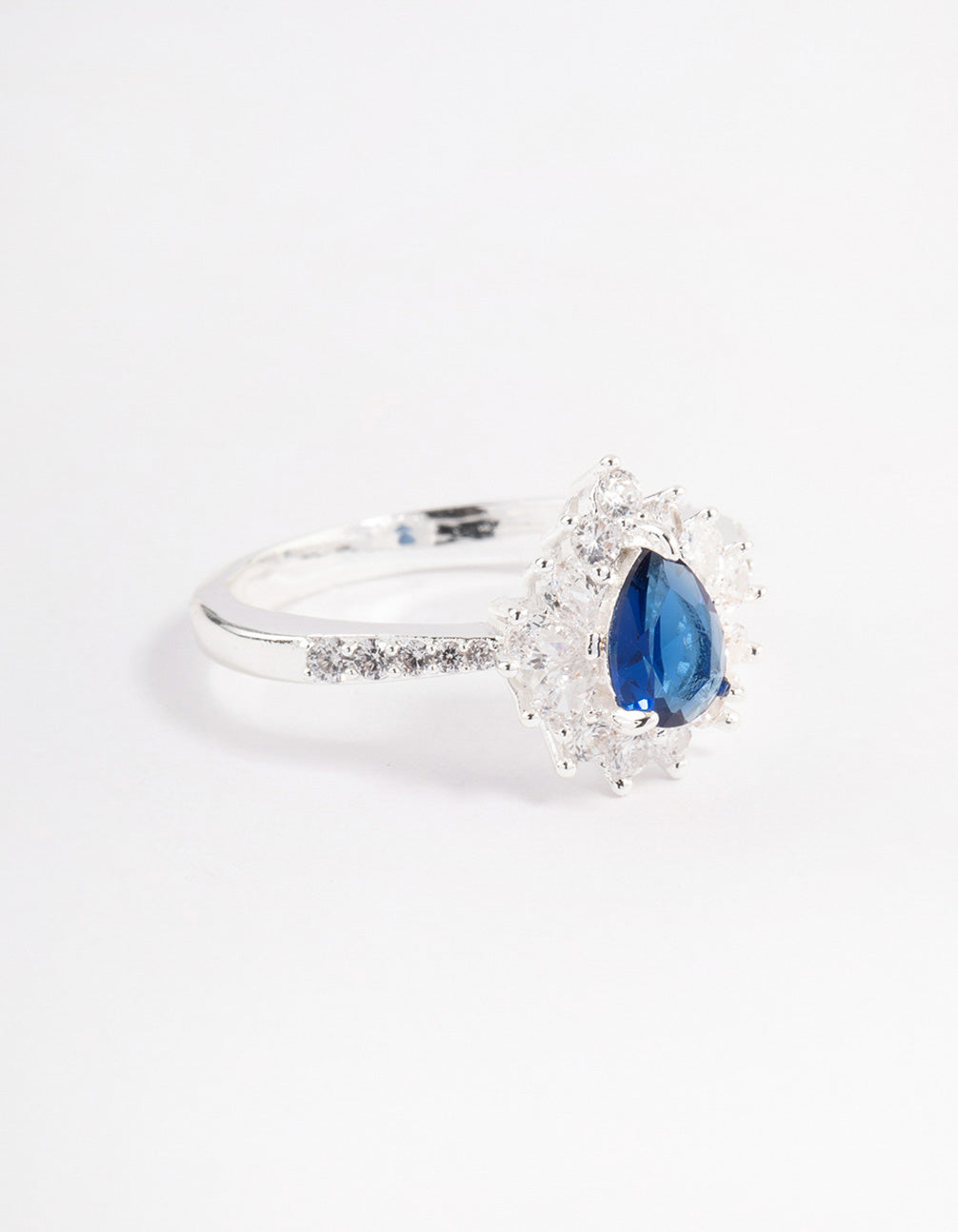 Showcasing a silver plated regal pear ring featuring a pear cut stone with statement styling side detail view
