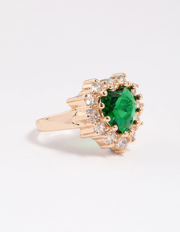 Showcasing a dainty heart ring in gold with lime green stone side detail view