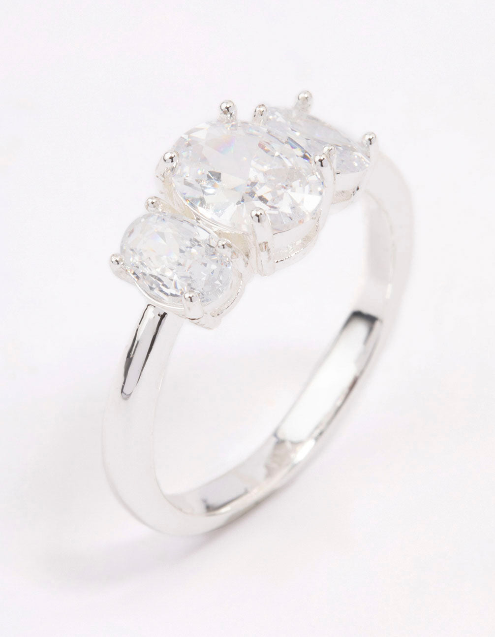 Showcasing a silver plated oval triple stone engagement ring with cubic zirconia side detail view