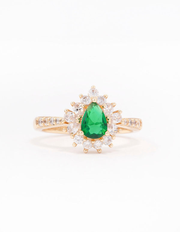 Showcasing a gold plated regal ring with pear cut cubic zirconia in green and clear close up view