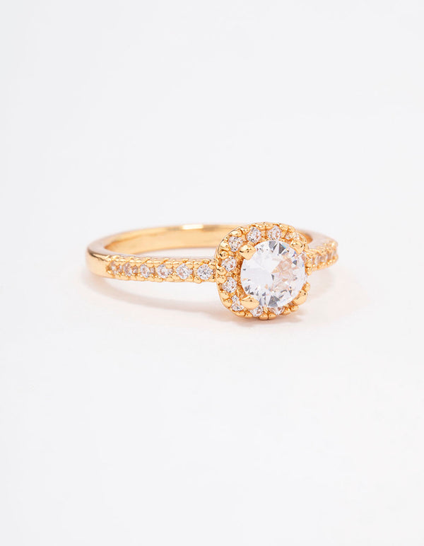 Crafted from gold plated metal, this mini cushion cubic zirconia engagement ring features a halo setting front view