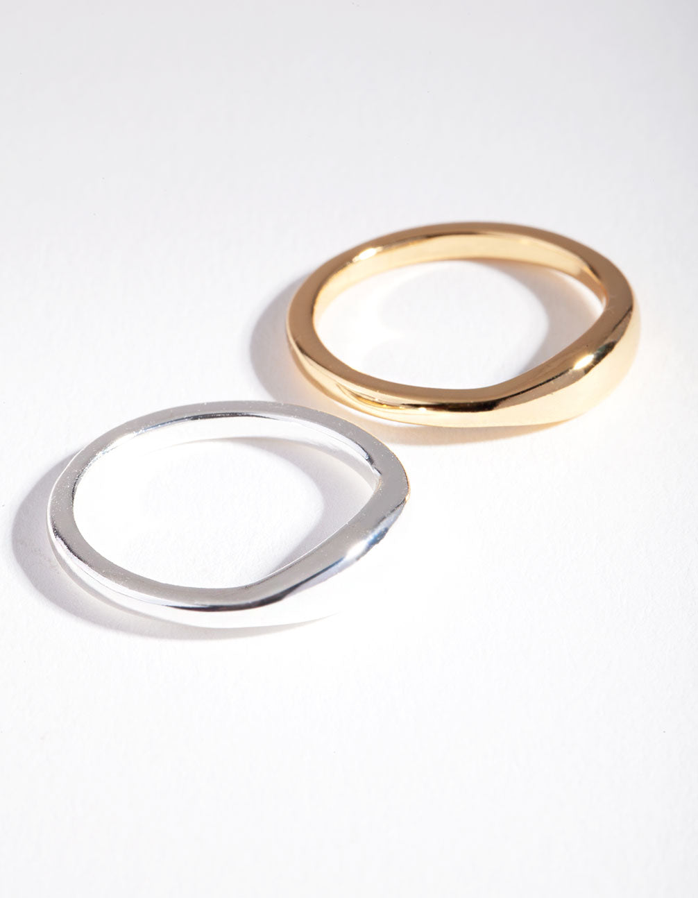 Showcasing a silver and gold plated wave band ring set front view