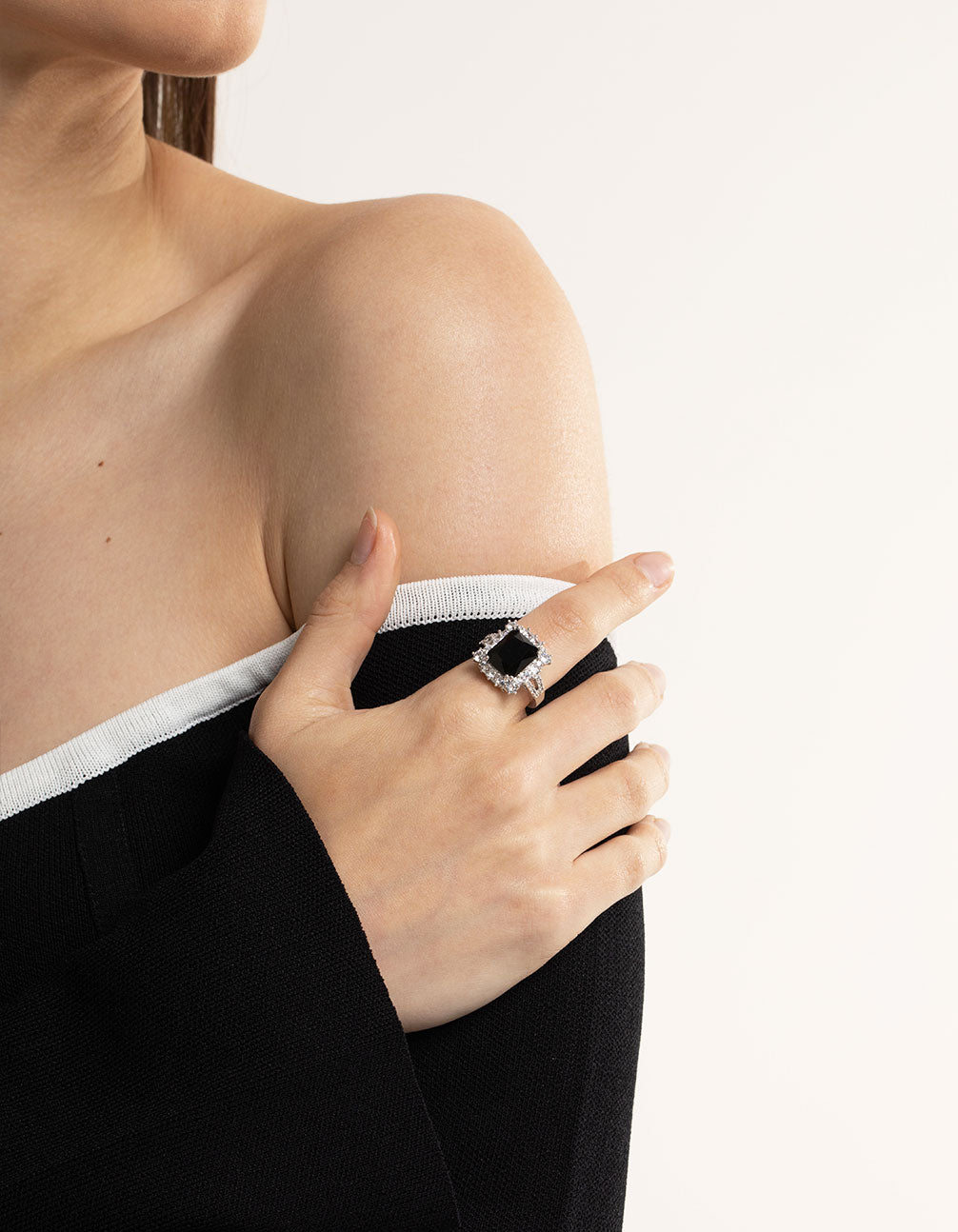 Elegant cubic zirconia ring featuring emerald cut stone in black and silver on finger view