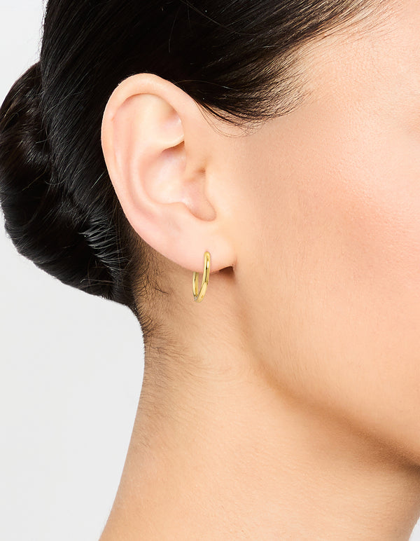 Featuring waterproof gold plated stainless steel thin clicker earrings in 18 MM size on ear view