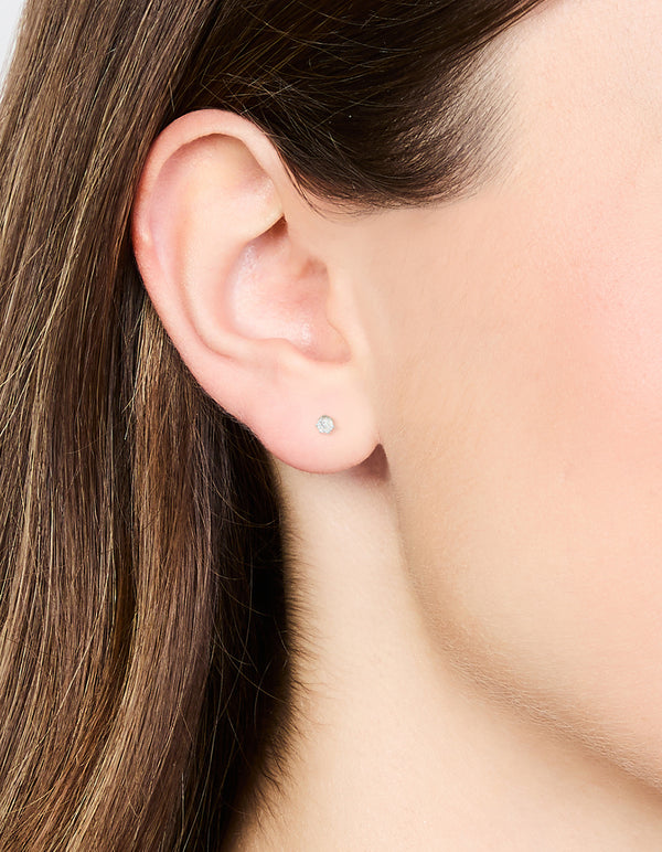 Stylish waterproof stainless steel cubic zirconia stud earrings in silver with 3mm stones on ear view