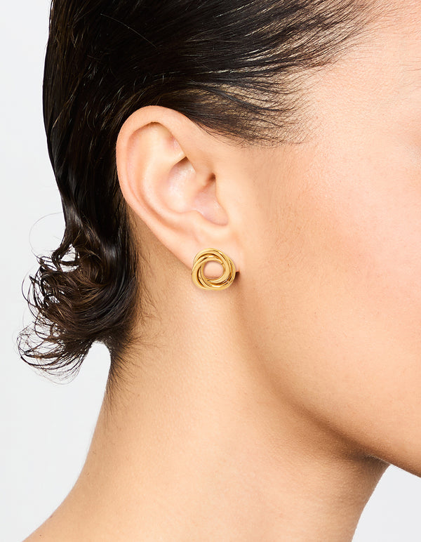 Highlighting waterproof gold plated stainless steel knotted doughnut stud earrings on ear view