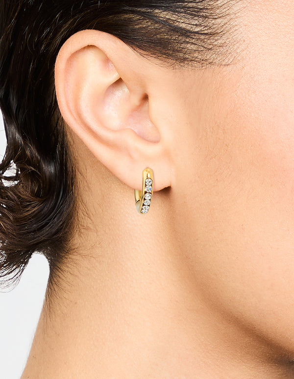 Featuring waterproof gold plated stainless steel round diamante clicker hoop earrings on ear view