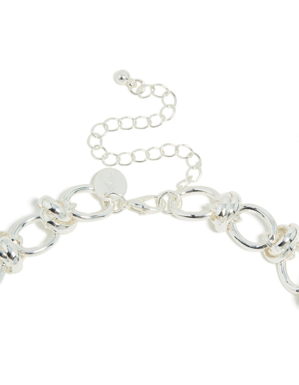 Highlighting a silver plated knotted chain necklace clasp detail view