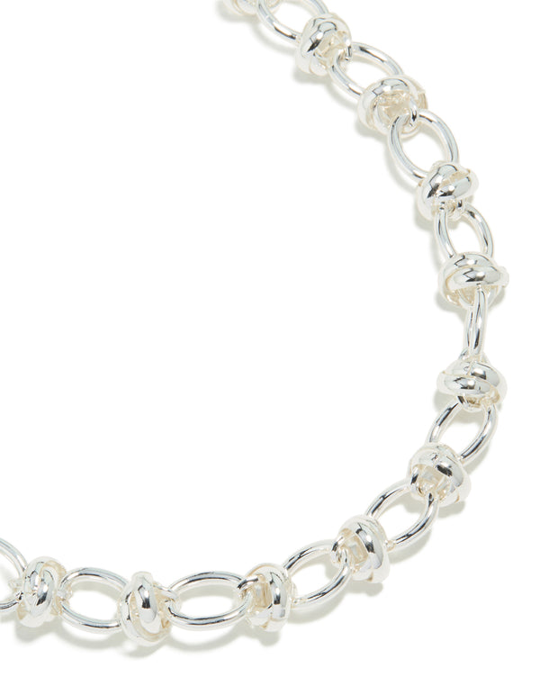 Showcasing a silver plated knotted chain necklace close up view