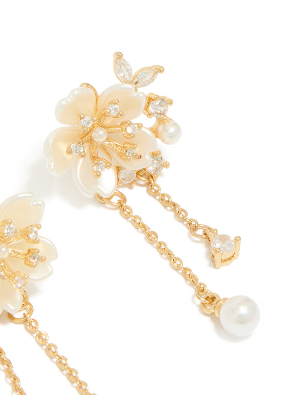Highlighting gold plated acrylic flower pearl drop earrings featuring statement style post detail view