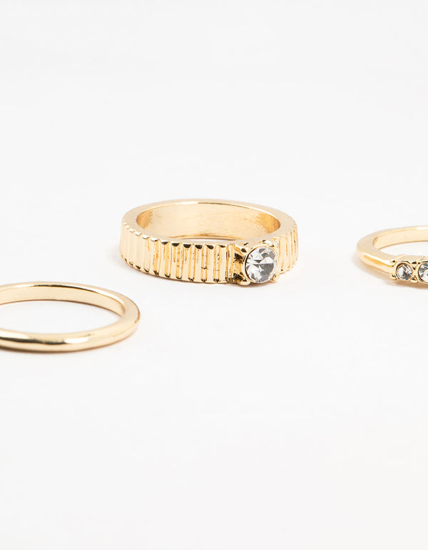 Elegant gold plated ribbed and diamante rings 4-pack featuring stackable design close up view