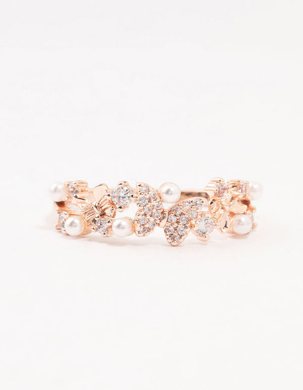 Crafted from rose gold plated material, this butterfly and pearl band ring close up view
