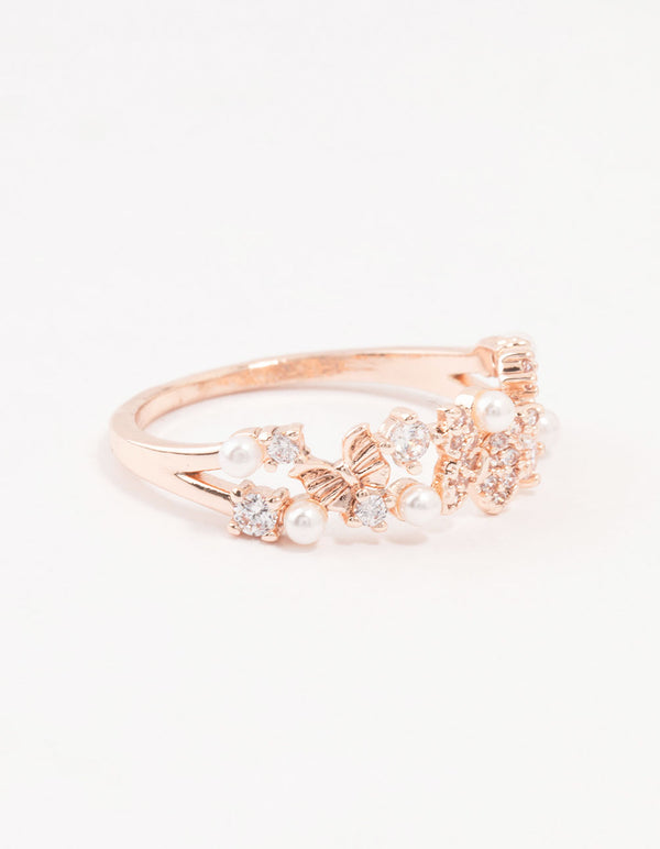 Showcasing a rose gold plated butterfly and pearl band ring front view