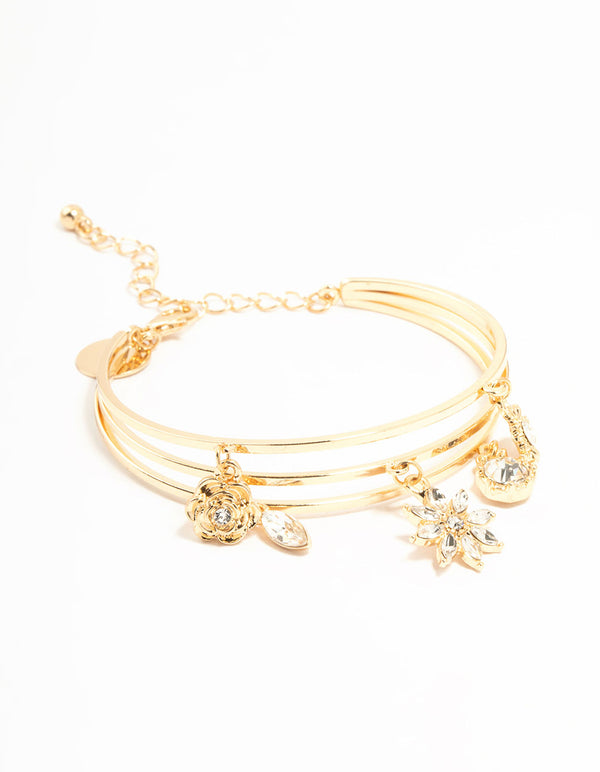 Showcasing a wrist cuff featuring floral charm details in gold front view