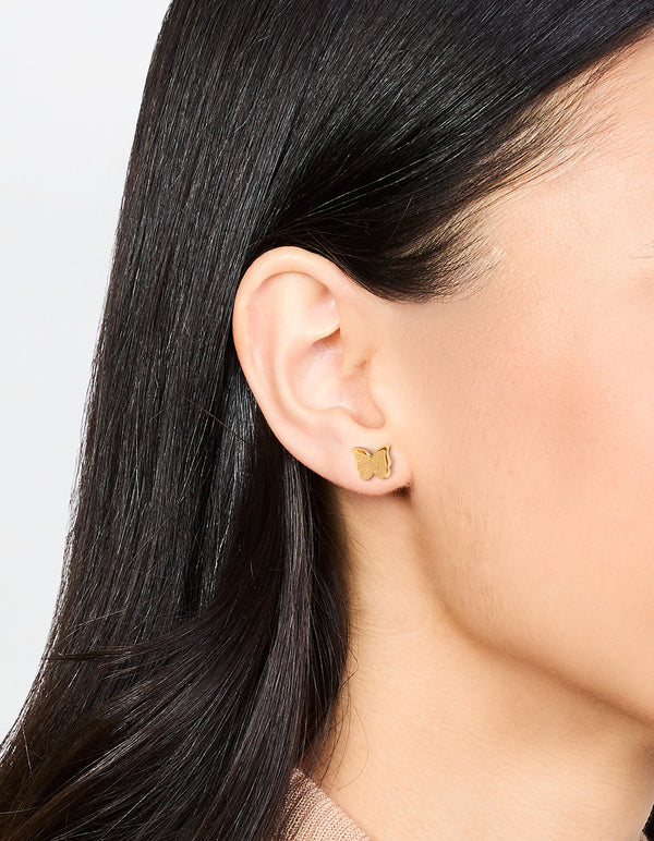 Elegant butterfly stud earrings in waterproof gold plated stainless steel with glitter finish on ear view