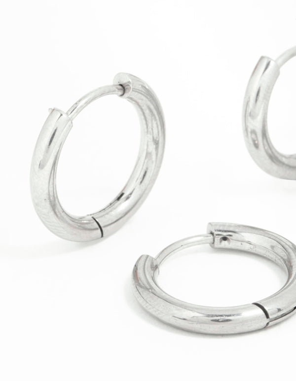 Showcasing surgical steel thick hoop earrings in a 2-pack with silver closure close up view