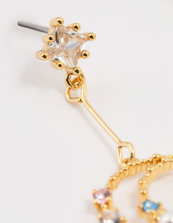 Designed with gold plated metal, these cubic zirconia moon drop earrings feature celestial and pearl accents post detail view