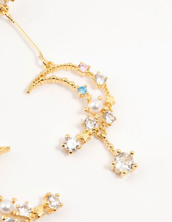 Highlighting gold plated cubic zirconia moon drop earrings with celestial and pearl details close up view
