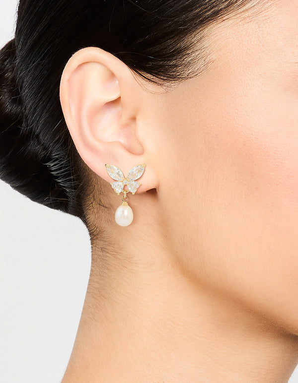 Elegant gold plated cubic zirconia butterfly pearl drop earrings on ear view