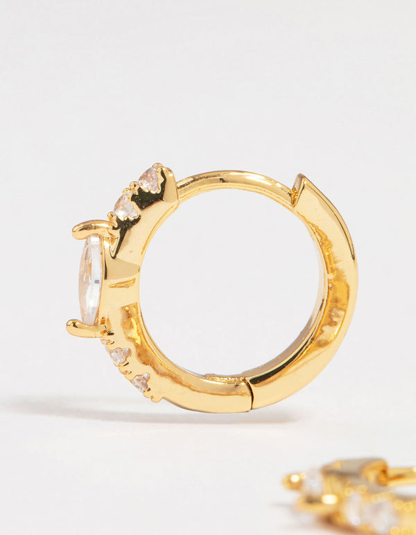 Showcasing gold plated diamante marquise pave huggie earrings close up view