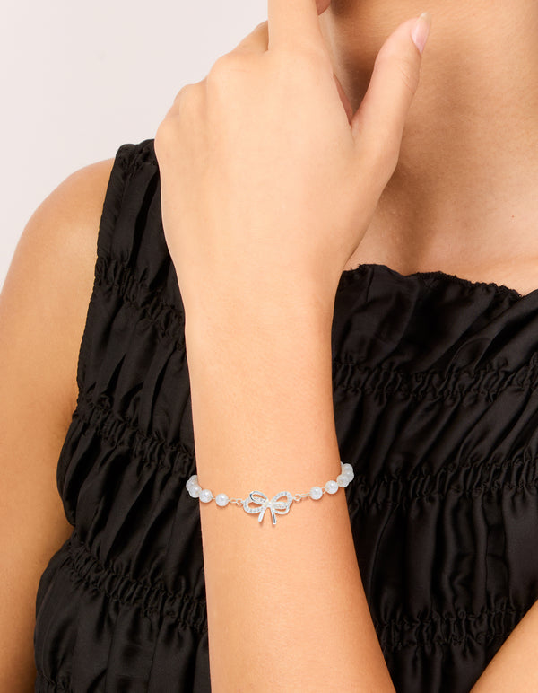 Crafted from silver plated material, this pearl double bow bracelet features on wrist view
