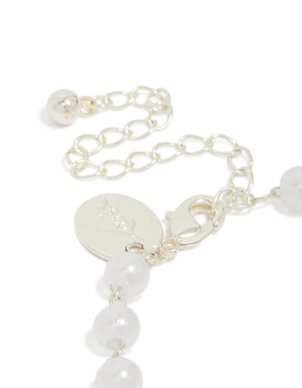 Featuring silver plated pearl double bow bracelet closure detail view
