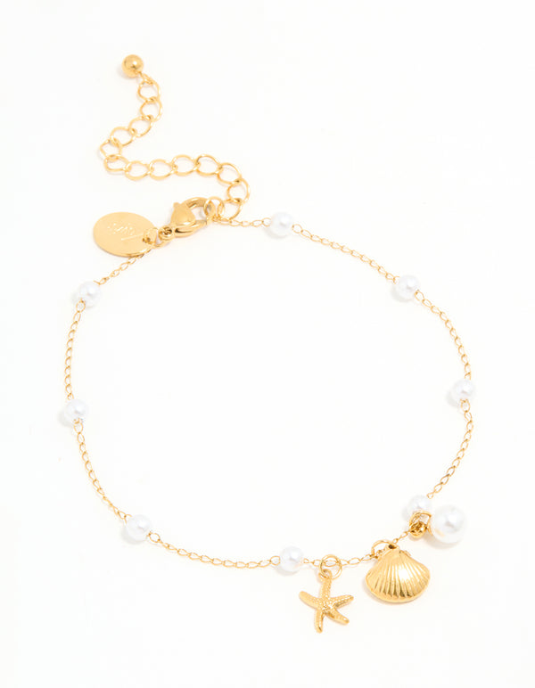 Introducing a waterproof gold plated stainless steel anklet adorned with ocean theme, pearl and shell accents front view