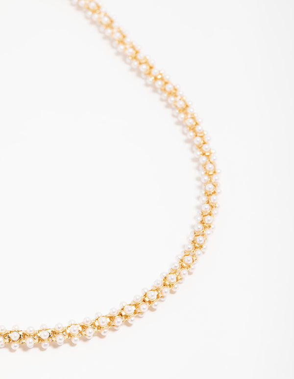 Showcasing a gold plated pearl fireball bracelet in white front view