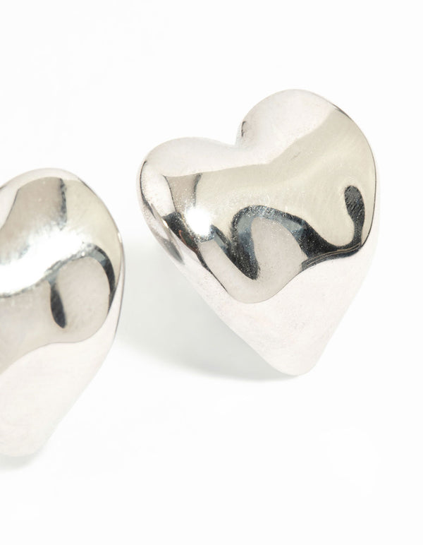 Highlighting waterproof stainless steel molten heart stud earrings in dainty silver construction post detail view