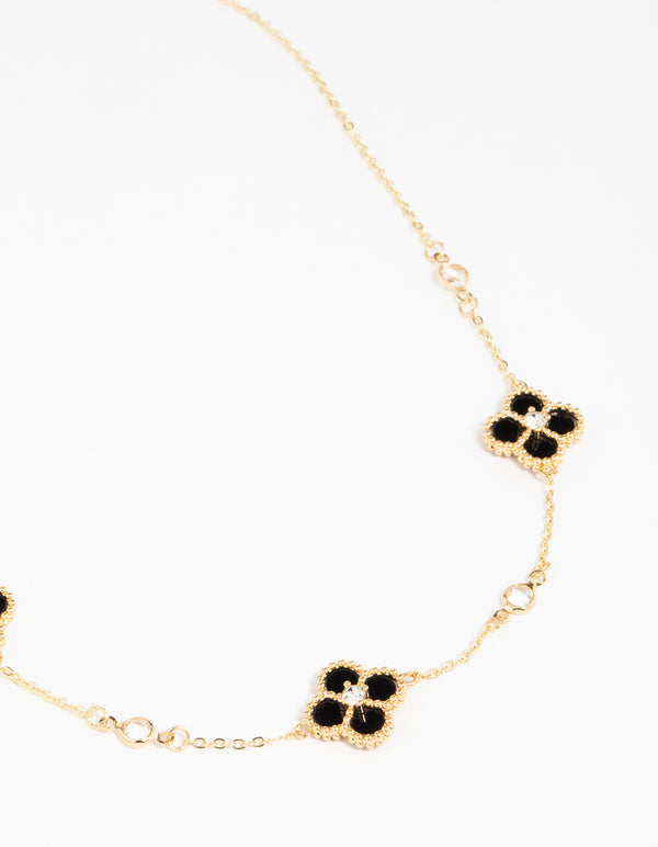 Crafted from gold plated metal, this cubic zirconia black flower pendant necklace features with crystal accents close up view