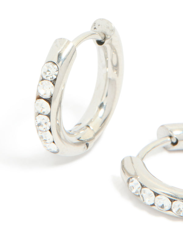 Highlighting waterproof stainless steel cubic zirconia round clicker huggie earrings in silver close up view