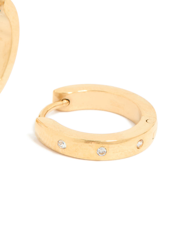 Crafted from waterproof gold plated stainless steel, these cubic zirconia trio huggie earrings feature clear accents in post detail view