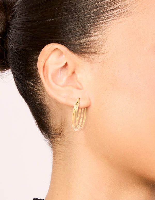 Featuring waterproof gold plated stainless steel double hoop earrings in gold on ear view
