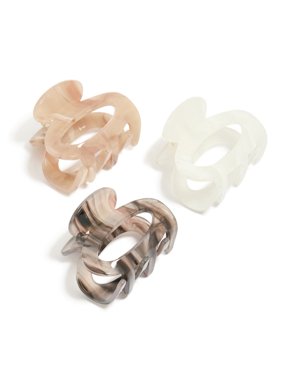 Presenting oval acrylic mini claw clips in a 3-pack featuring tan, ivory, and rosy brown tones front view