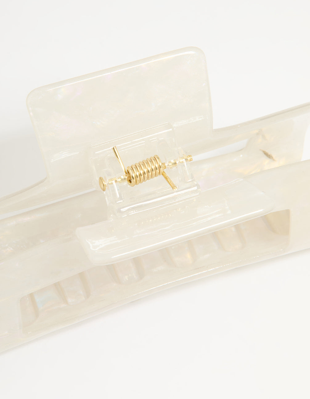 Featuring a solid print ivory and acrylic rectangle claw clip detail view